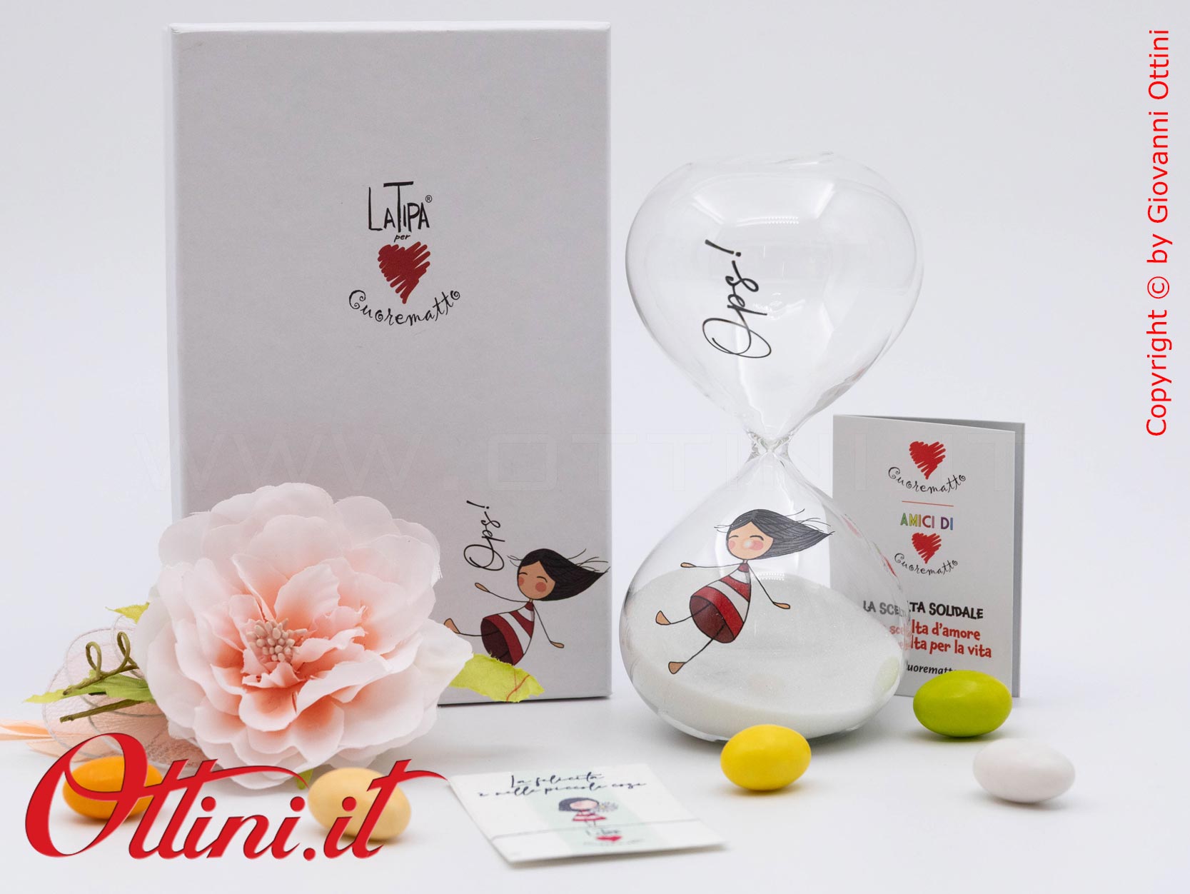 DC004 - La Clessidra 15 Minuti La Tipa di Cuorematto in vetro borosilicato è una bomboniera solidale giovane che sostiene i Frati dell'Antoniano di Bologna.